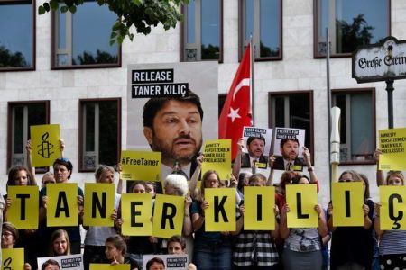 Amnesty urges releases of its Turkey head after year in jail