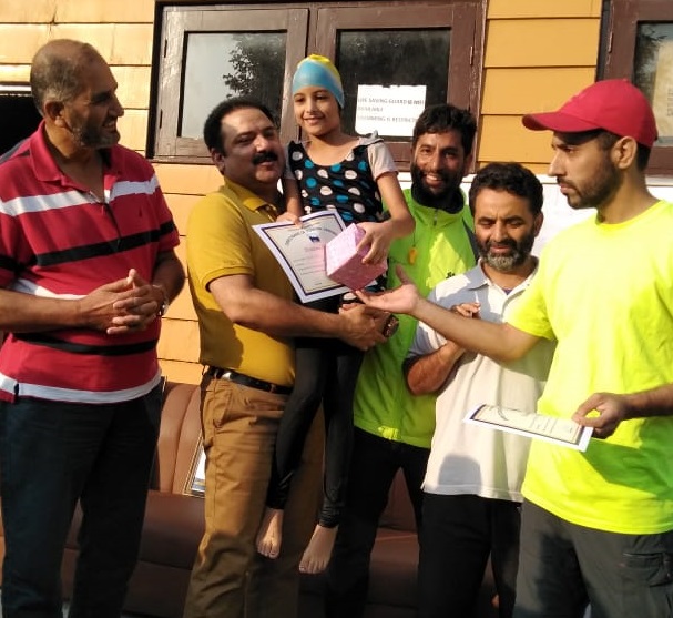 Director Tourism distributes certificates among swimmers at Nigeen