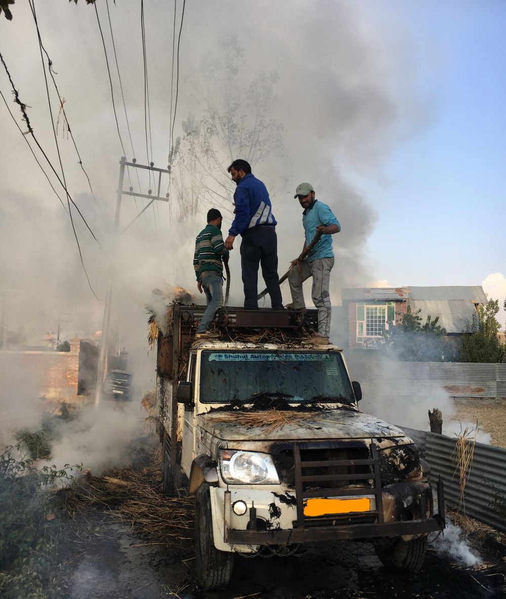 Vehicle catches fire after coming in contact with low-lying wires on Budgam Khanpora road