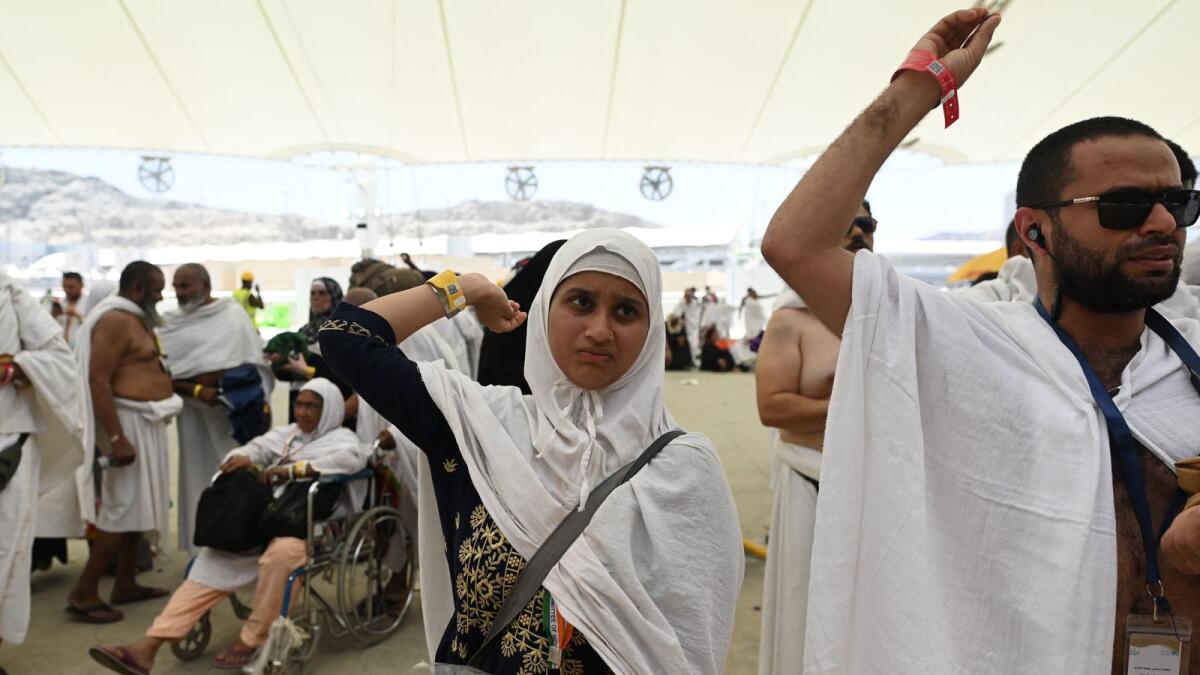 Muslims at Hajj pilgrimage brave intense heat to cast stones at pillars representing the devil