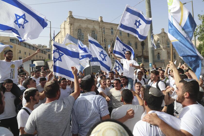 Israeli nationalists march through Palestinian area of Jerusalem, some chanting ‘Death to Arabs’