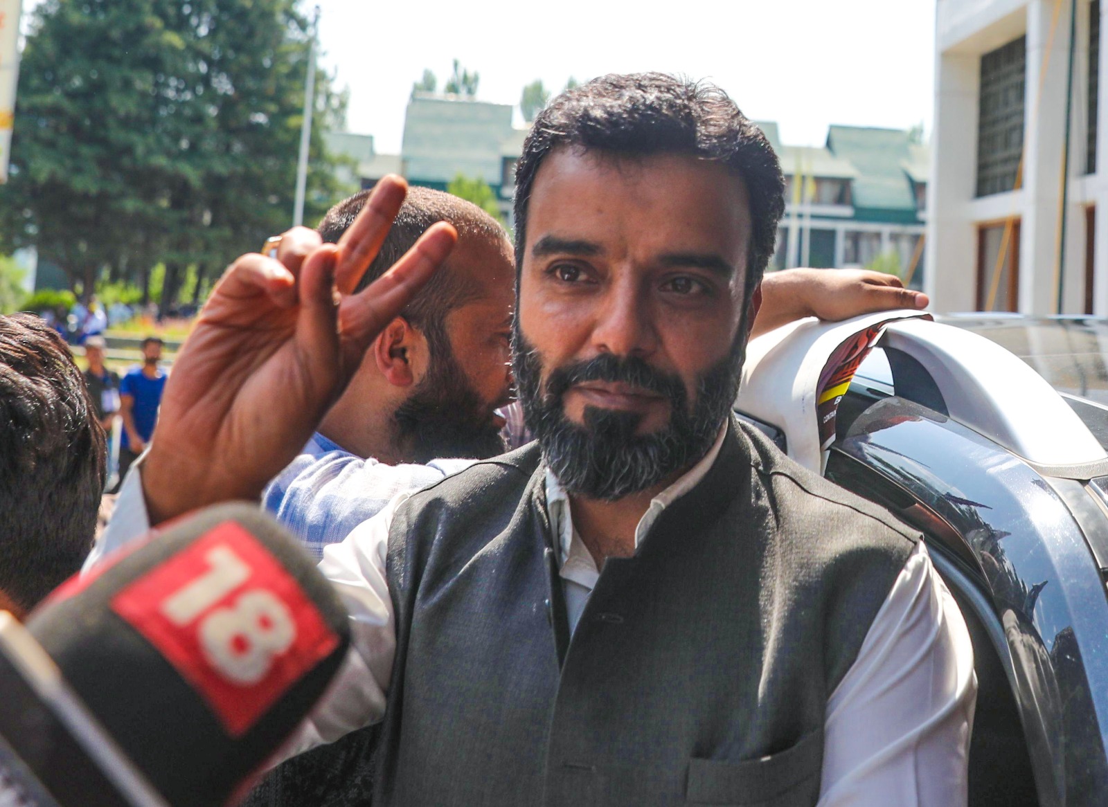 JKNC candidate from Srinagar constituency Syed Aga Ruhuallah flashes victory sign during counting of votes for Lok Sabha elections, Srinagar