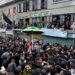 Women devotees watch from rooftops and windows as thousands take part in the Zuljinah procession in downtown Srinagar