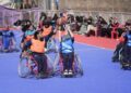 Female students with special needs play a game of sitting volleyball at a volunteer-run Medicare society in Srinagar