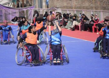 Female students with special needs play a game of sitting volleyball at a volunteer-run Medicare society in Srinagar