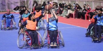 Female students with special needs play a game of sitting volleyball at a volunteer-run Medicare society in Srinagar