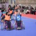Female students with special needs play a game of sitting volleyball at a volunteer-run Medicare society in Srinagar