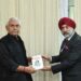 Commodore Dalbir Singh Sodhi presents his books to LG Sinha