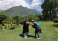 On the third day of Eid, tourists visit the Mughal Gardens in Srinagar and pose for photographs dressed like locals.