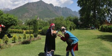 On the third day of Eid, tourists visit the Mughal Gardens in Srinagar and pose for photographs dressed like locals.