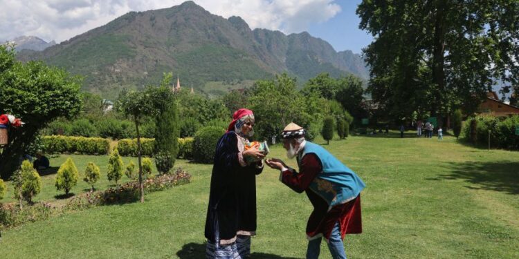 On the third day of Eid, tourists visit the Mughal Gardens in Srinagar and pose for photographs dressed like locals.