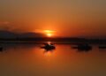 Sunset paints the waters of Dal Lake in golden hues as shikaras rest along the calm waters in Srinagar on Friday.