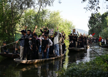 A traditional mourning procession was taken out on Dal waters on the 9th day of Muharram