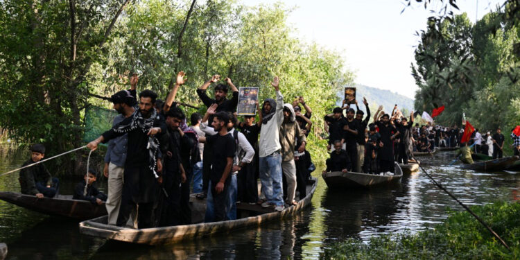 A traditional mourning procession was taken out on Dal waters on the 9th day of Muharram