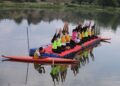 Participants perform yoga on a floating platform during an event marking International Yoga Day at Pokhrabal Lake in Srinagar.