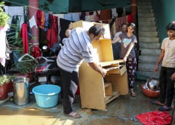 Residents struggle to clear sludge inundating homes after record rainfall floods Jammu localities